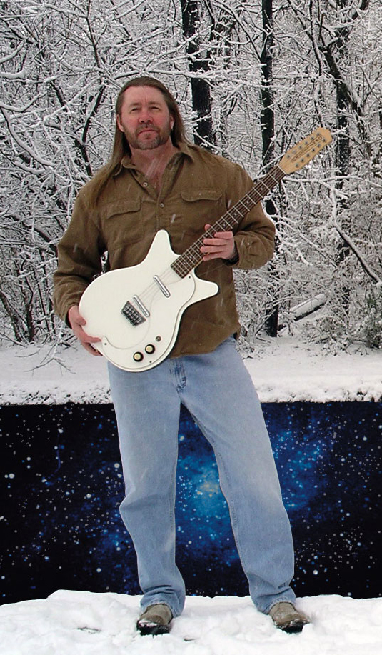Monty Milne with white guitar in snowstorm