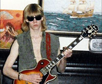 Monty Milne at age eighteen posed with Ibanez electric guitar